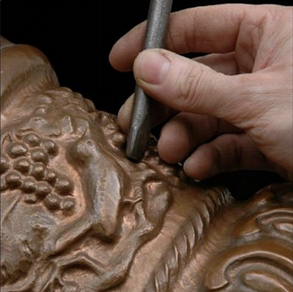 master_coppersmith_carving_copper_vase