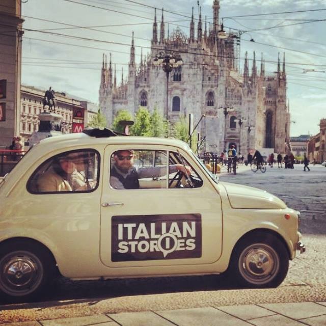 Italian stories team in vintage fiat 500 in front of Duomo of Milan